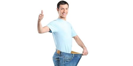 Woman Comparing Jeans After Weight Loss Standing At Home Stock Photo   Download Image Now  iStock